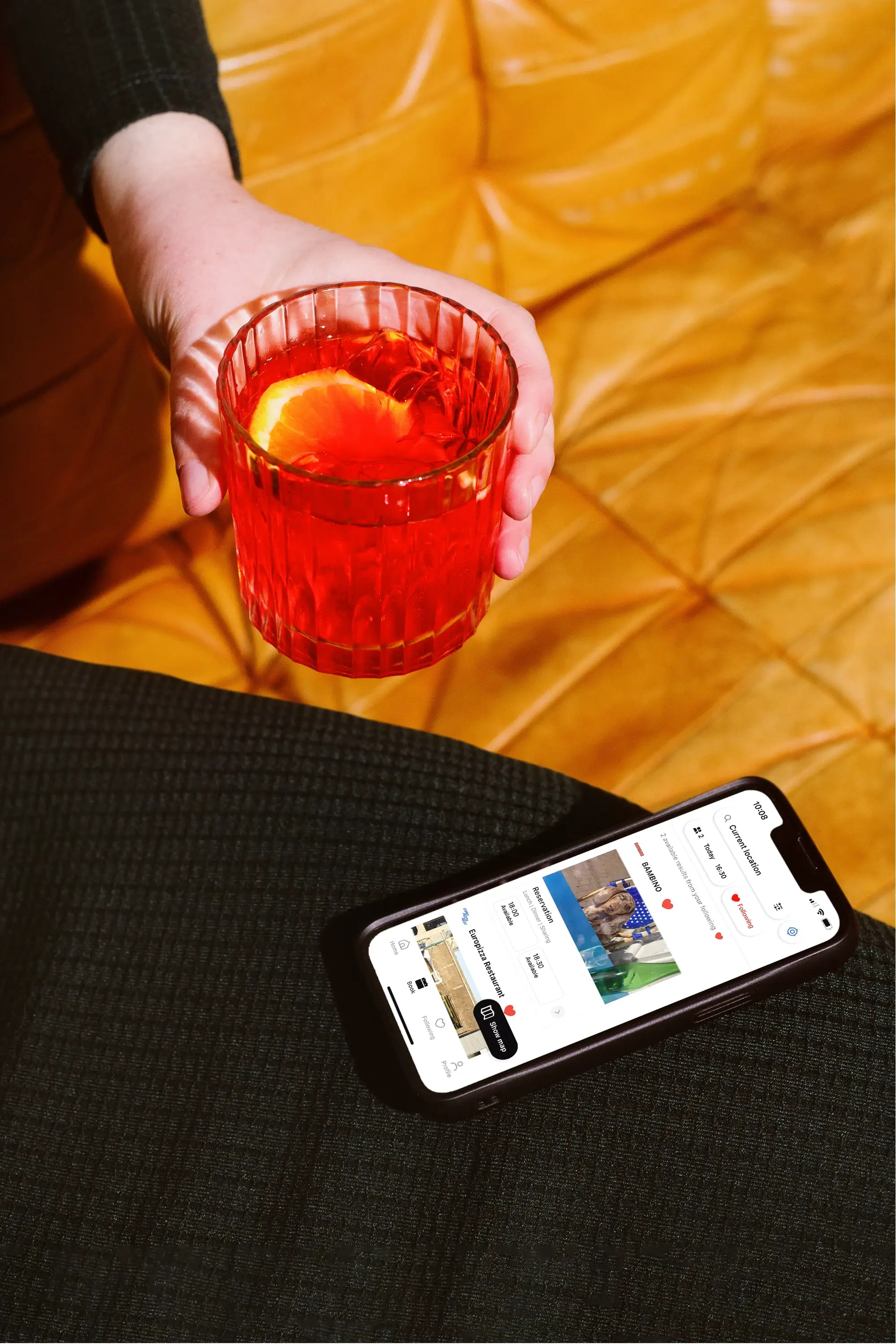 Making a booking with the Table app on iPhone with a drink in hand